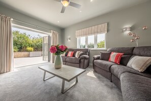 Appletrees, Burnham Market: Sitting room with comfortable seating and garden access