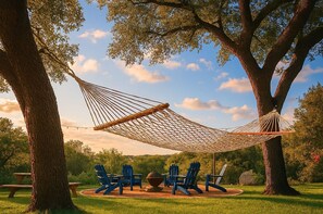 Your own hammock with the view of the fire pit.