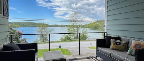 covered breezeway with lake views; propane grill