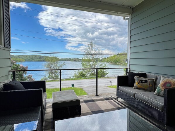 covered breezeway with lake views; propane grill