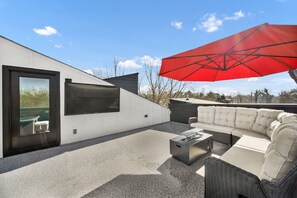 Stunning aerial shot of the private rooftop with city skyline views, 70” HDTV, fire pit, outdoor furniture seating, BBQ grill and bar. What more could you want?!
