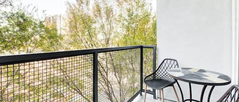 Revel in the outdoors! Our balcony offers a cozy and inviting space to relax."