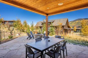 Private back patio with outdoor fire pit, fireplace and gas grill