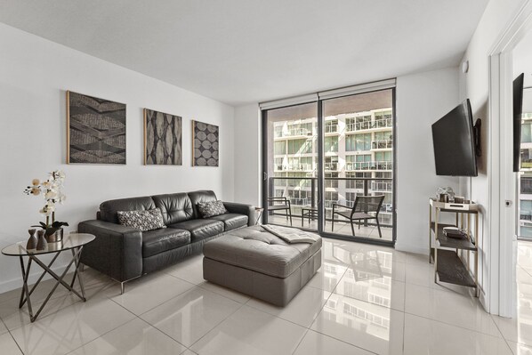 Relax and unwind in our spacious and comfortable living room with an amazing view of Brickell. 