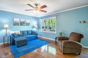 Spacious living area with lounge seating, tv, and picture window