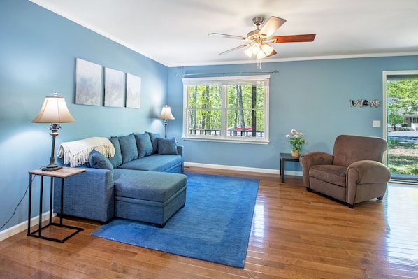 Spacious living area with lounge seating, tv, and picture window