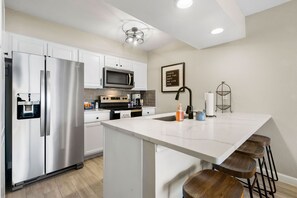 Open concept kitchen allows for a lake view. Well equipped for the family chef.