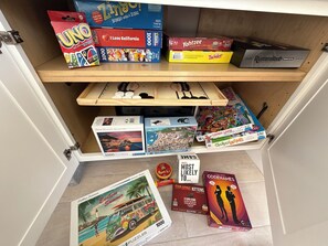 Fun games and puzzles located in the living room cabinet next to fireplace