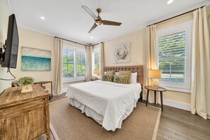 - Spacious king bedroom with breezy coastal decor and plenty of natural light - Plantation shutters, warm lighting, and hardwood floors add a restful, refined feel - Unwind with your favorite show on the mounted flat screen TV in total comfort