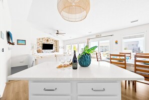 The newly renovated kitchen overlooks the living and dining area and ocean views.