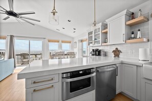New kitchen is open to the dining and living areas, and you can take in ocean views while you prepare meals, snacks and cocktails