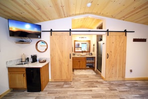 Private bathroom area with barn doors.