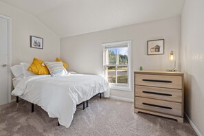 Bedroom from view of the living area includes full size bed, dresser and closet.