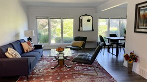 Upper living room with lots of natural lights next to dinning room and kitchen