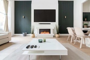 Spacious lounge with 90" Smart TV, high ceilings & full air conditioning