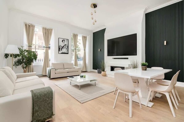 Spacious lounge with 90" Smart TV, high ceilings & full air conditioning