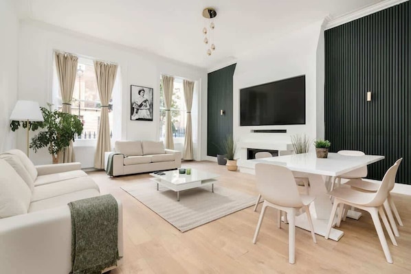 Spacious lounge with 90" Smart TV, high ceilings & full air conditioning