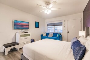 A Queen Size Bed Paired with a Cozy Sofa and Television – Your Perfect Retreat for Rest and Entertainment.