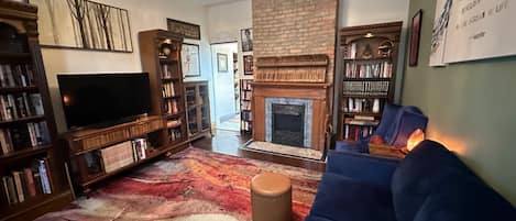 Living room. Reading material, wifi, Roku, and a comfy blue velvet seating.