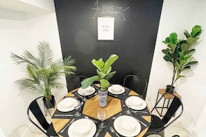 The bright open concept dining area comfortably seats 6 and features a massive chalk board wall!