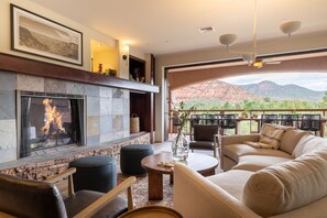 Living room features a fireplace and opens to the deck.