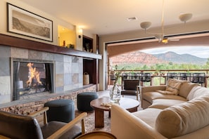 Living room features a fireplace and opens to the deck.