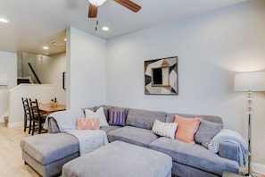 The open-concept living space, complete with a dining area, facilitates effortless conversation with family and friends.