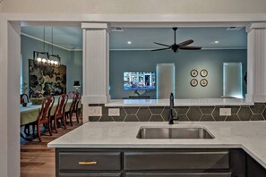 Kitchen over looks family room, TV and sectional