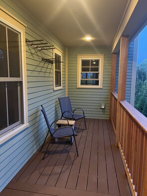 Side porch.  Ski storage racks on wall. 