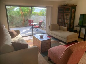 Living room opens onto private gated yard.