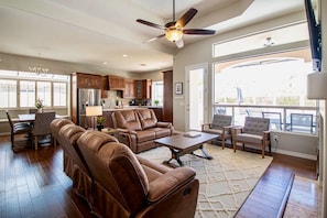 Living room, dining room and kitchen all have views over the patio and bordering desert landscape.