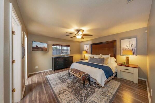 Primary bedroom with king-size bed, walk-in closet, and en-suite bathroom