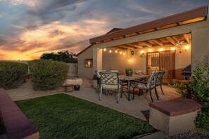 Covered back patio, grill, and enjoyable outdoor dining space