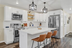 Kitchen with quartz countertops and brand new stainless steel appliances
