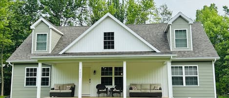 Third house from the bluff - with large driveway and spacious front porch. 