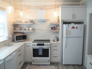 OVERVIEW:  The newly remodeled kitchen with all appliances including a dishwasher and a cute little coffee bar.