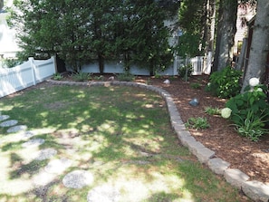 EXTERIOR: The lovely garden area that is fully fenced in.