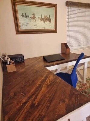 Large desk for working from home. Plus use of screen and printer.