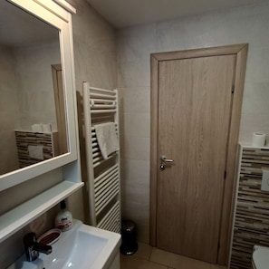 BATHROOM WITH SHOWER CABIN, TOILET, BATHROOM CABINET, WASHER AND DRYER