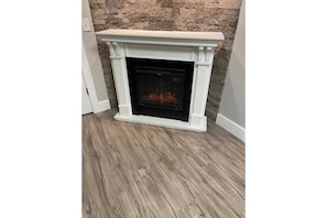Convenient electric fireplace in the kitchen/living room for instant warmth!