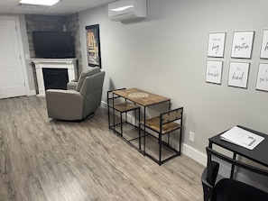 Desk, dining table, and recliners for relaxing while watching a movie!