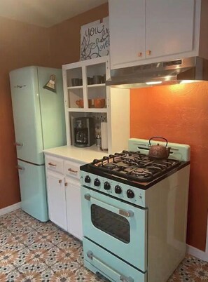small but functional appliances and pantry stocked with basics