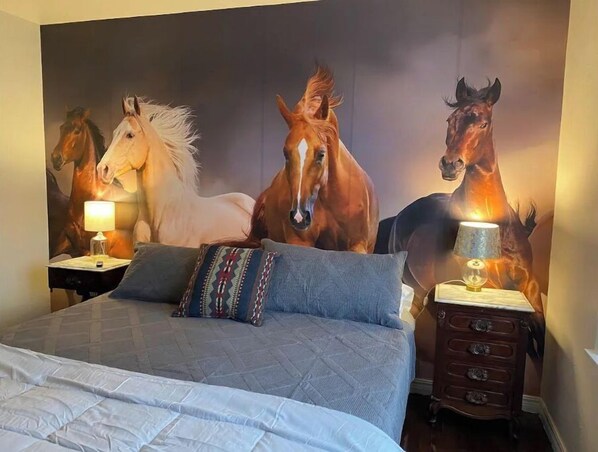 Master bedroom with king bed, side tables, reading lamps, vanity station, closet