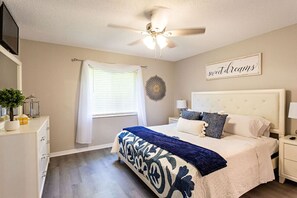 Master bedroom with king bed and TV