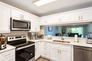 Fully stocked kitchen with new appliances and countertops