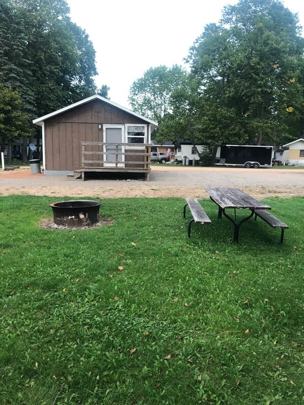 Quaint cottage with small porch area. Only a few steps makes for easy access.