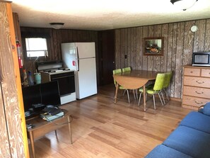 Kitchen/dining area has full gas range, full fridge, coffee maker, toaster, and kitchen essentials