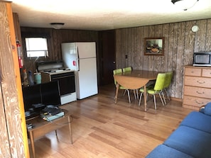 Kitchen/dining area has full gas range, full fridge, coffee maker, toaster, and kitchen essentials