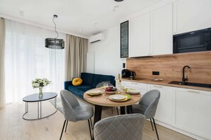 The elegant living room featuring a double sofa bed.
