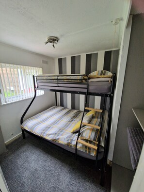 Bunk bed with a double bed and a single bed above
